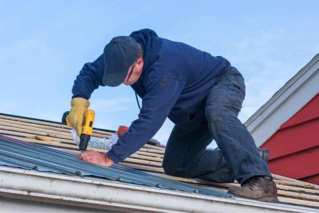 Roofing technician sealing a roof leak on a residential property in NJ.