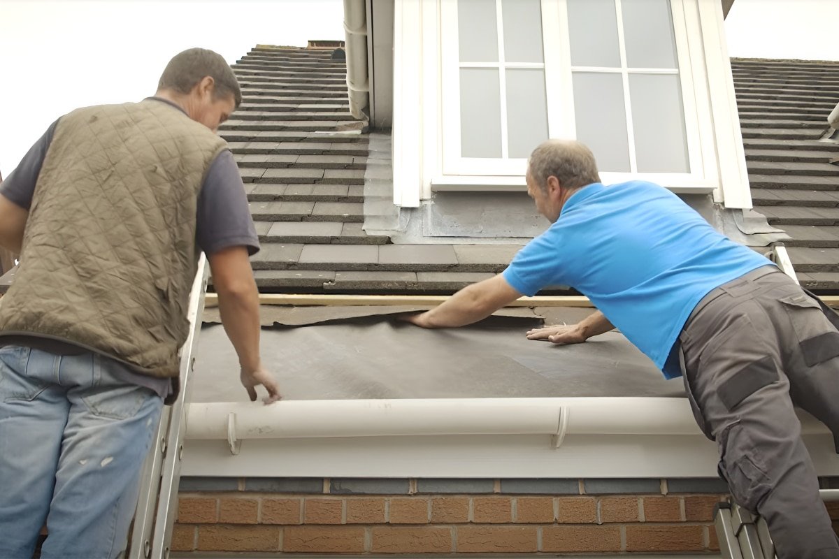 Two roofers performing roof leak repair on a residential home in New Jersey.