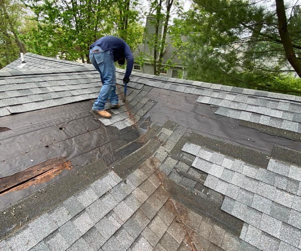 Roof repair project in NJ – replacing damaged shingles on residential home Roof repair in NJ - contractor replacing damaged shingles and underlayment